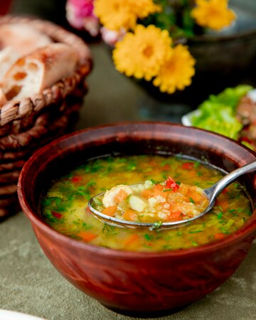vegetable soup served with herbs