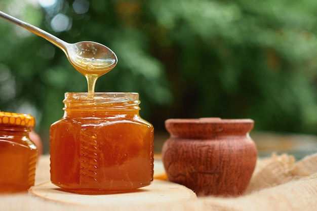 honey flows from steel spoon